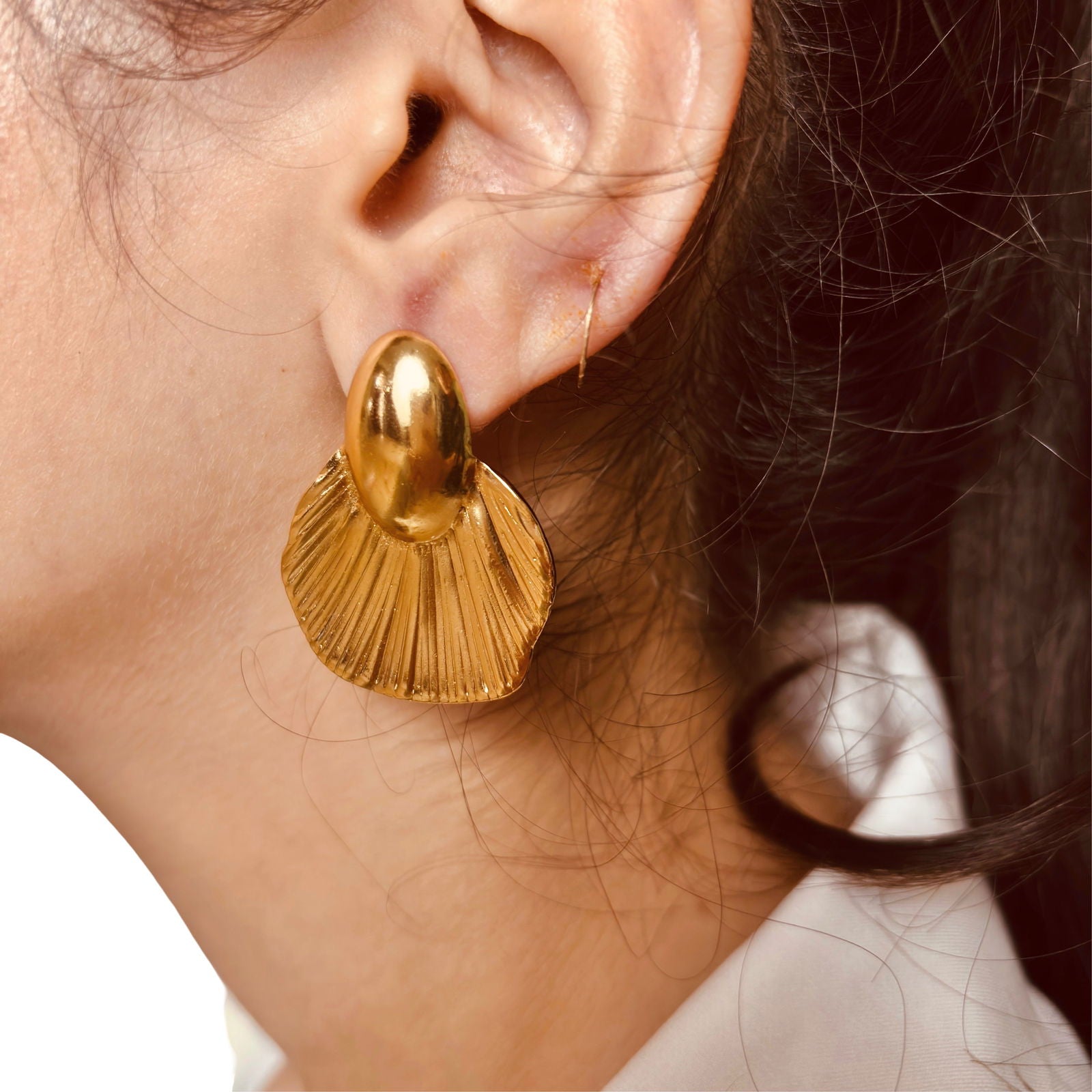 Model's side shot showing large fish-tail studs with reflective gold finish - waterproof elegant oversized fish-tail studs gold plated stainless steel earring gift for her under 2000 - anti tarnish premium 18K gold plated stainless steel reflective studs earrings festive gift for her under 2000 - hypoallergenic office wear 18K gold plated stainless steel earrings birthday anniversary gift for her under 1500 - Rakhi gifts for sister under 2000 - jewelry Raksha Bandhan gifts - everyday gold studs under 1500