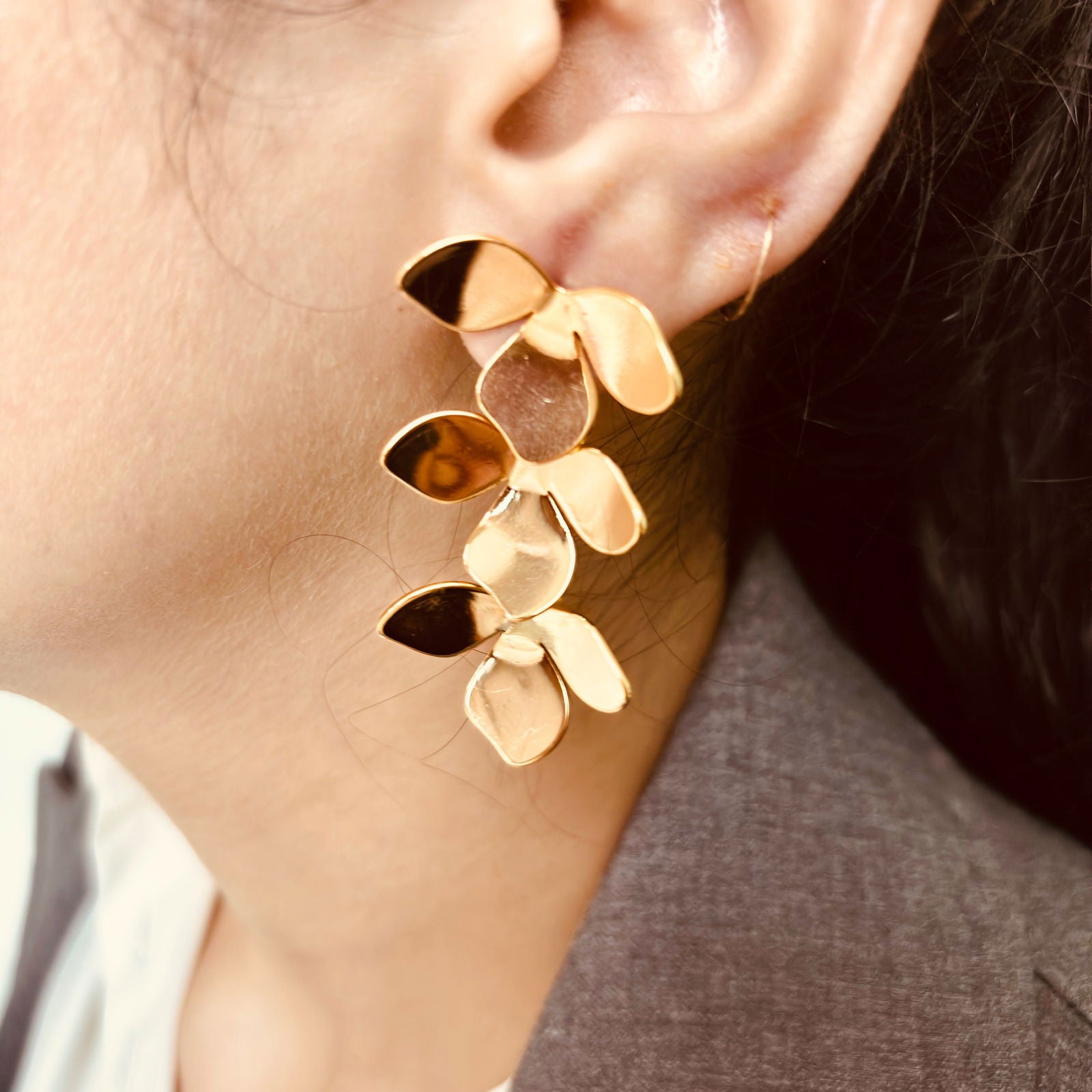 Model wearing clover petal earrings in polished gold finish - Statement elegant gold plated earrings - hypoallergenic anti‑tarnish waterproof nickel‑free lead‑free gold plated earrings - scratch‑resistant fade‑resistant water‑resistant gold plated earrings