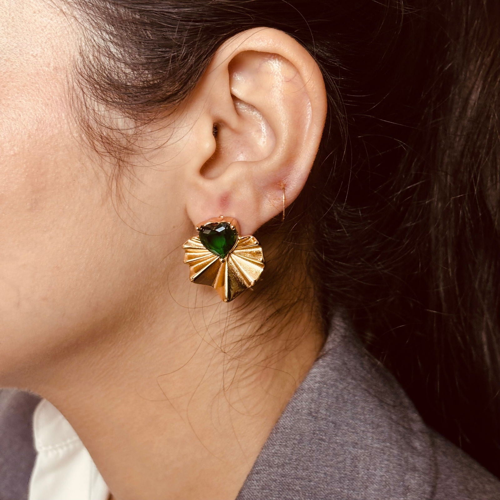 Model wearing emerald heart studs – romantic colored sparkle - dainty chic minimalist elegant gold plated earrings - hypoallergenic anti‑tarnish waterproof nickel‑free lead‑free gold plated earrings - scratch‑resistant fade‑resistant water‑resistant gold plated earrings 