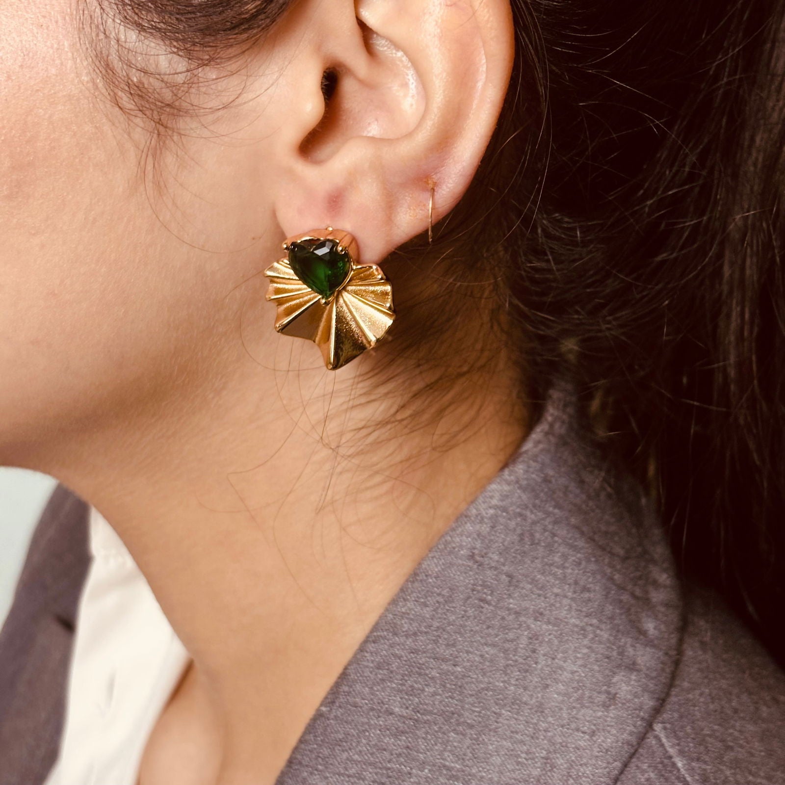 Model's side shot showing earring green gemstone detail and shine - dainty chic minimalist elegant gold plated earrings - hypoallergenic anti‑tarnish waterproof nickel‑free lead‑free gold plated earrings - scratch‑resistant fade‑resistant water‑resistant gold plated earrings 