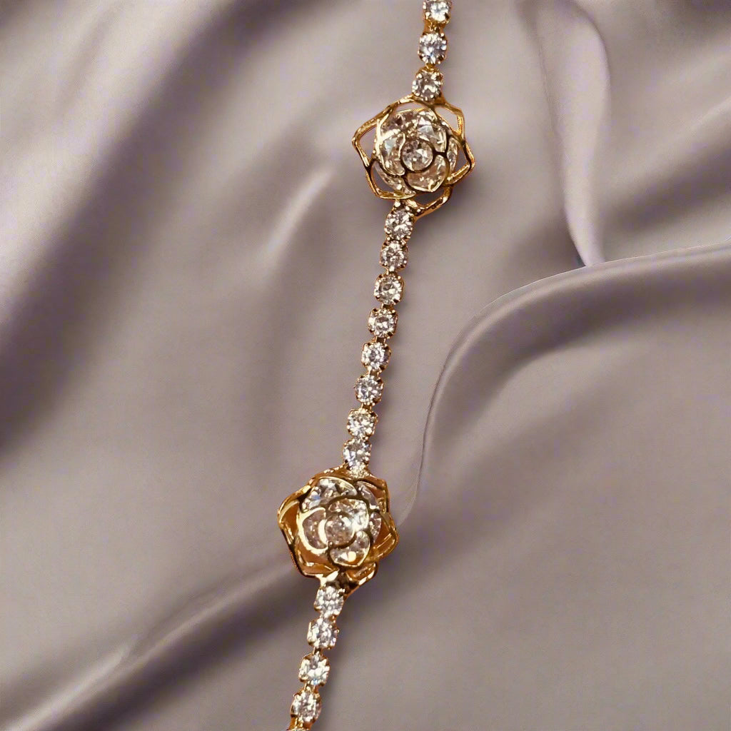 flat lay on satin cloth of elegant waterproof 18K gold plated cz tennis bracelet - hypoallergenic premium cz tennis bracelet gift for her under 2000 -  waterproof chic cz gold tennis bracelet anniversary gift under 2000 - affordable gold tennis bracelet stainless steel gift under 1500  - hypoallergenic cz tennis bracelet everyday wear - silver tennis bracelet gift for her - Rakhi gifts for sister under 2000 - jewelry Raksha Bandhan gifts