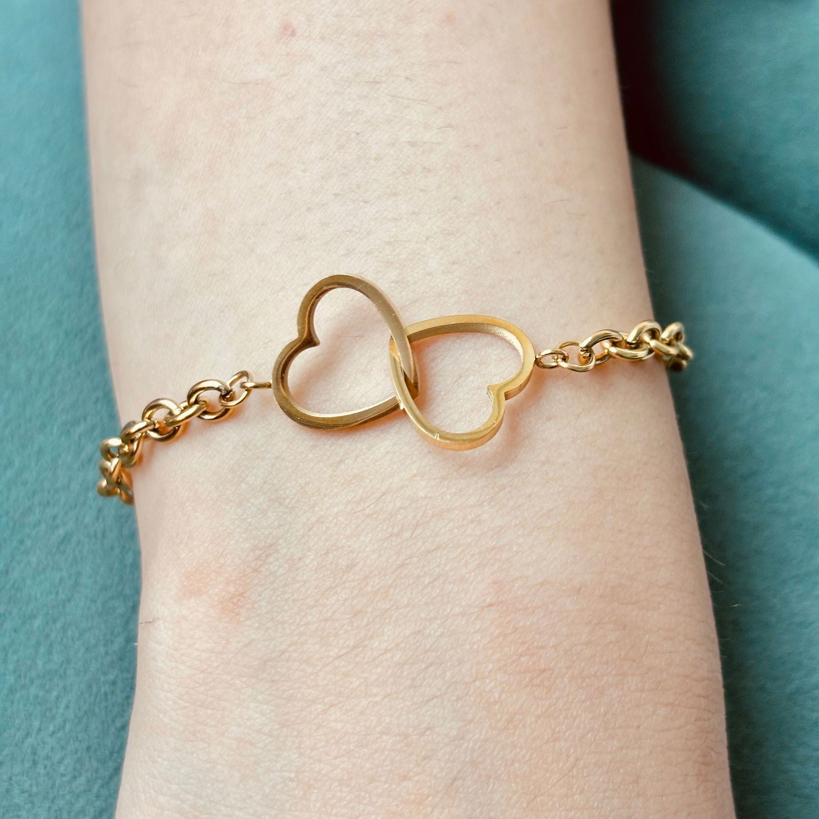 Close-up of gold heart links with polished finish and chain detail