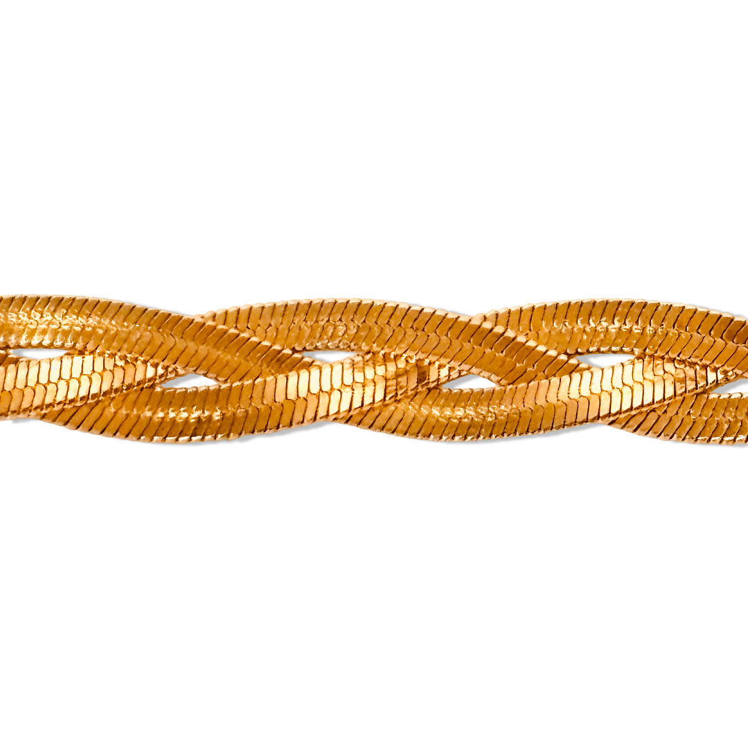 Close-up of braided gold bracelet highlighting snake chain weave