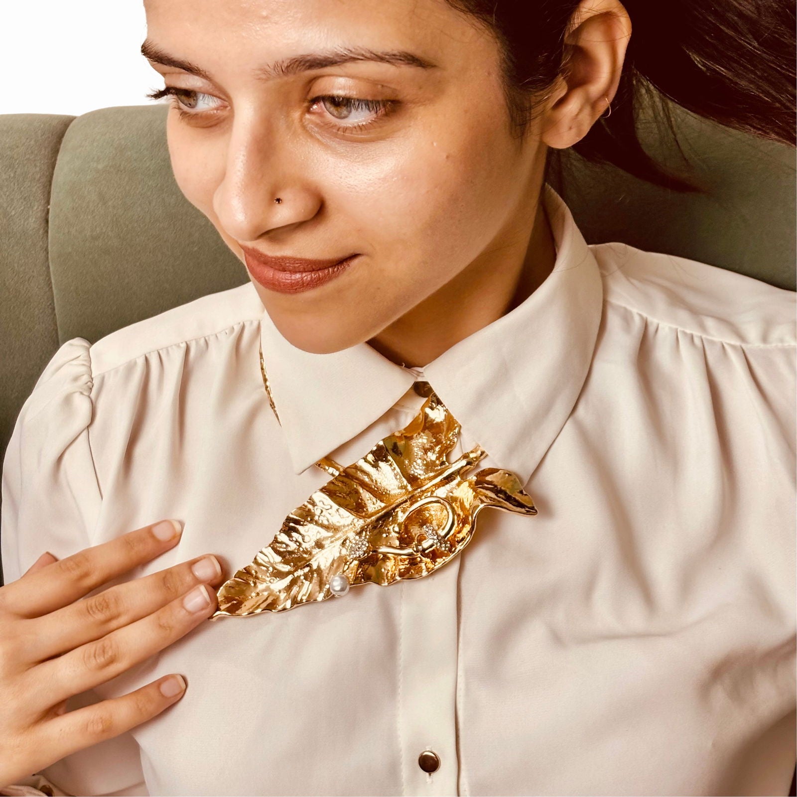 Model wearing golden leaf hasli necklace – bold botanical neckline