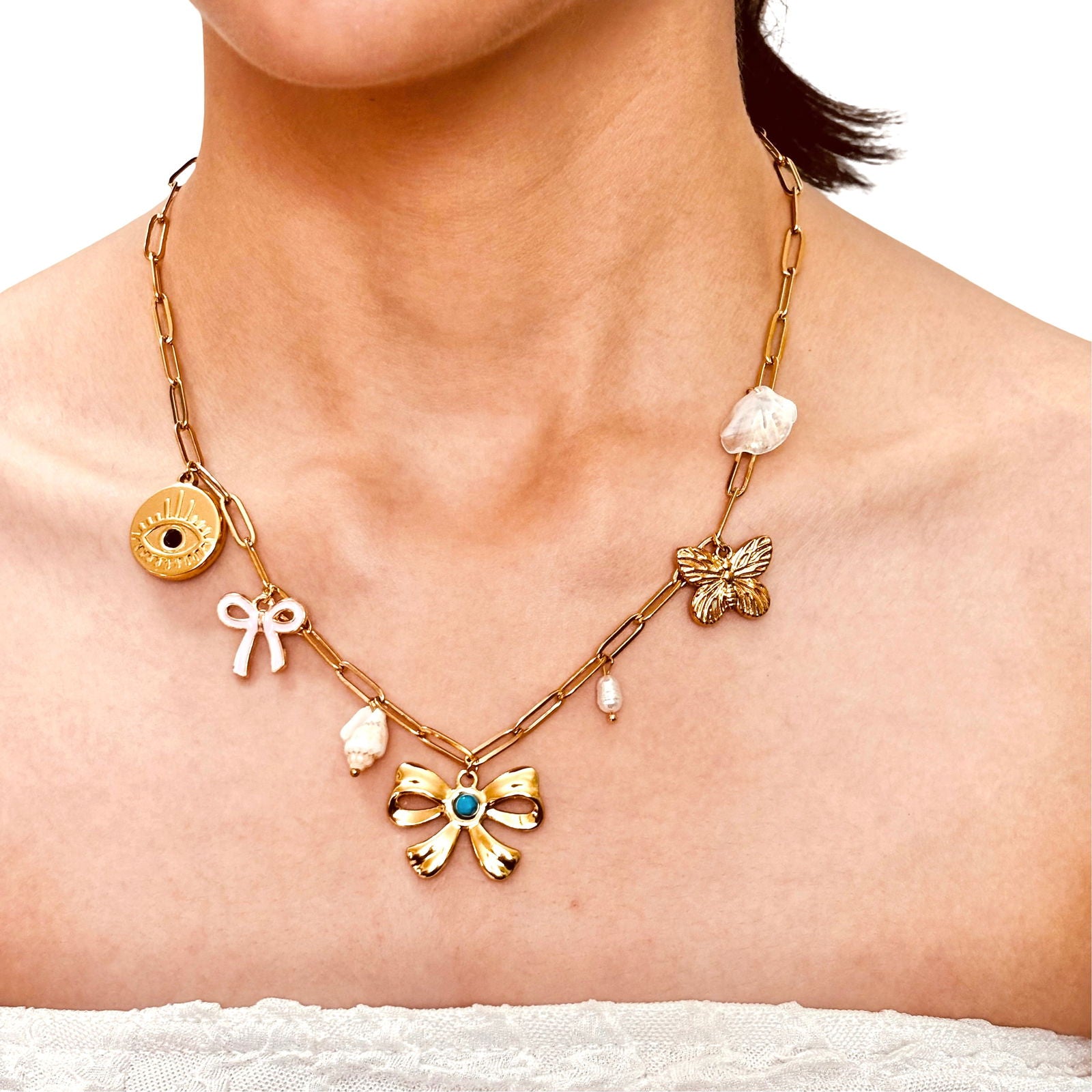 Close-up shot of model's neck showing anti-tarnish evil eye and bow charm gold-plated baroque pearl charm necklace birthday gift for her under 2000 - waterproof dainty minimalist gold plated stainless steel charm necklace anniversary gifts ideas under 2000 - hypoallergenic gold necklace festive gifts idea under 2000 - Rakhi gifts for sister under 2000 - jewelry Raksha Bandhan gifts