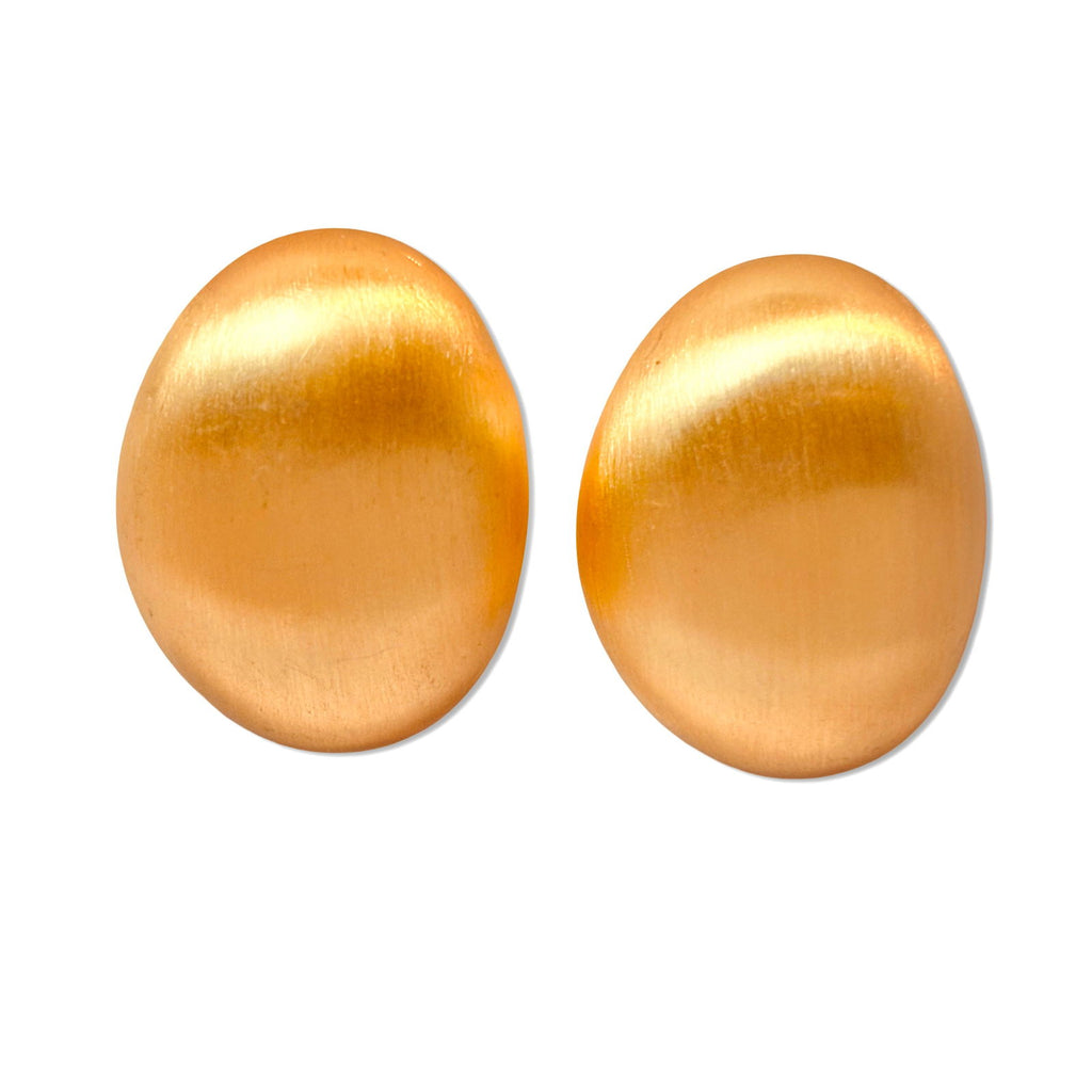 Close-up of flat-lay smooth oval surface with reflective finish - dainty chic minimalist elegant gold plated earrings - hypoallergenic anti‑tarnish waterproof nickel‑free lead‑free gold plated earrings - scratch‑resistant fade‑resistant water‑resistant gold plated earrings 