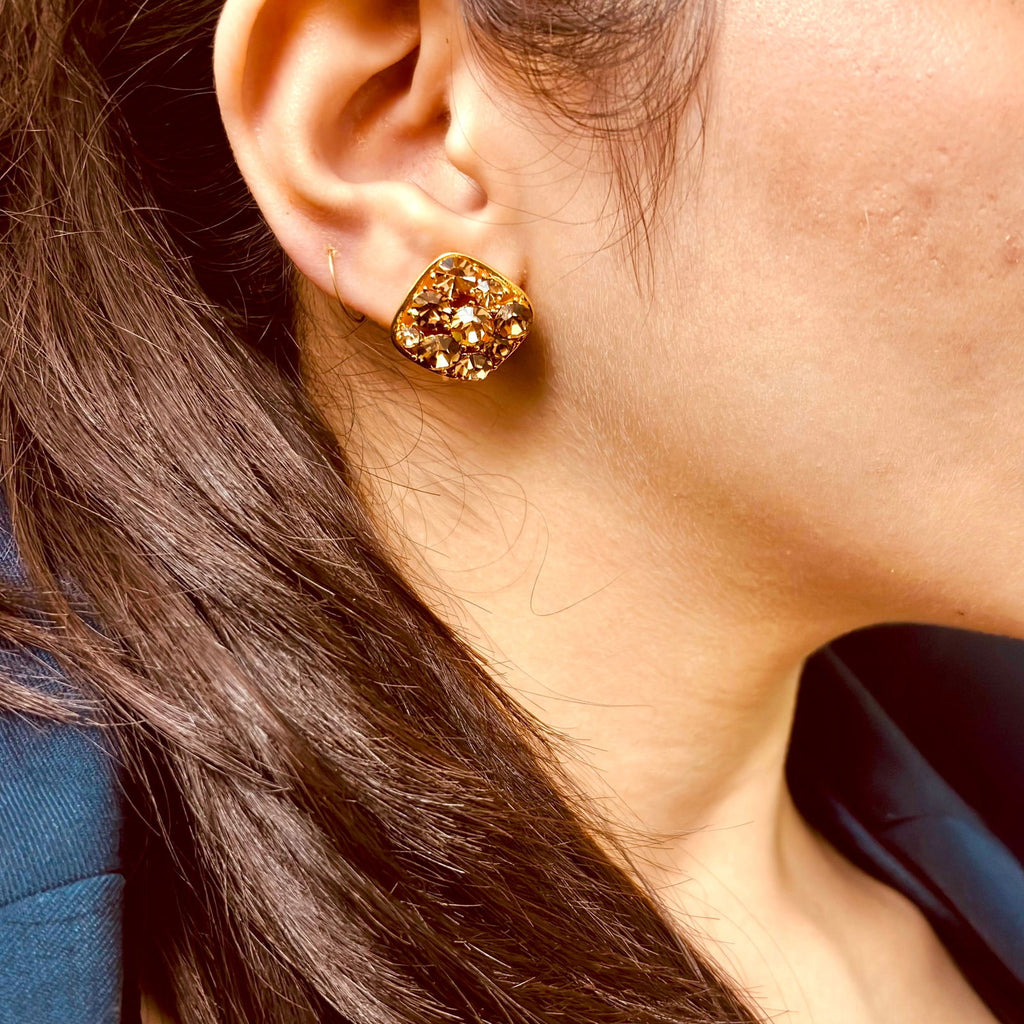 Model's close-up of waterproof festive Austrian crystal clip-on studs gold plated stainless steel earring gift for her under 2000 - anti tarnish premium 18K gold plated stainless steel crystal earrings festive gift for her under 2000 - hypoallergenic dainty 18K gold plated stainless steel earrings birthday anniversary gift for her under 1500 -  - Rakhi gifts for sister under 2000 - jewelry Raksha Bandhan gifts - gold studs under 1500