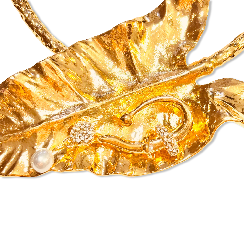 Close-up of gold hasli necklace featuring textured leaf design