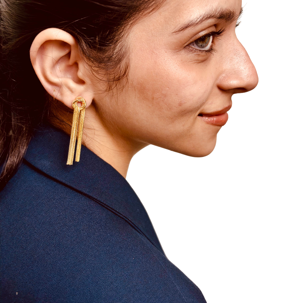 Model's side profile showing delicate chain earrings with knot – perfect for office to party