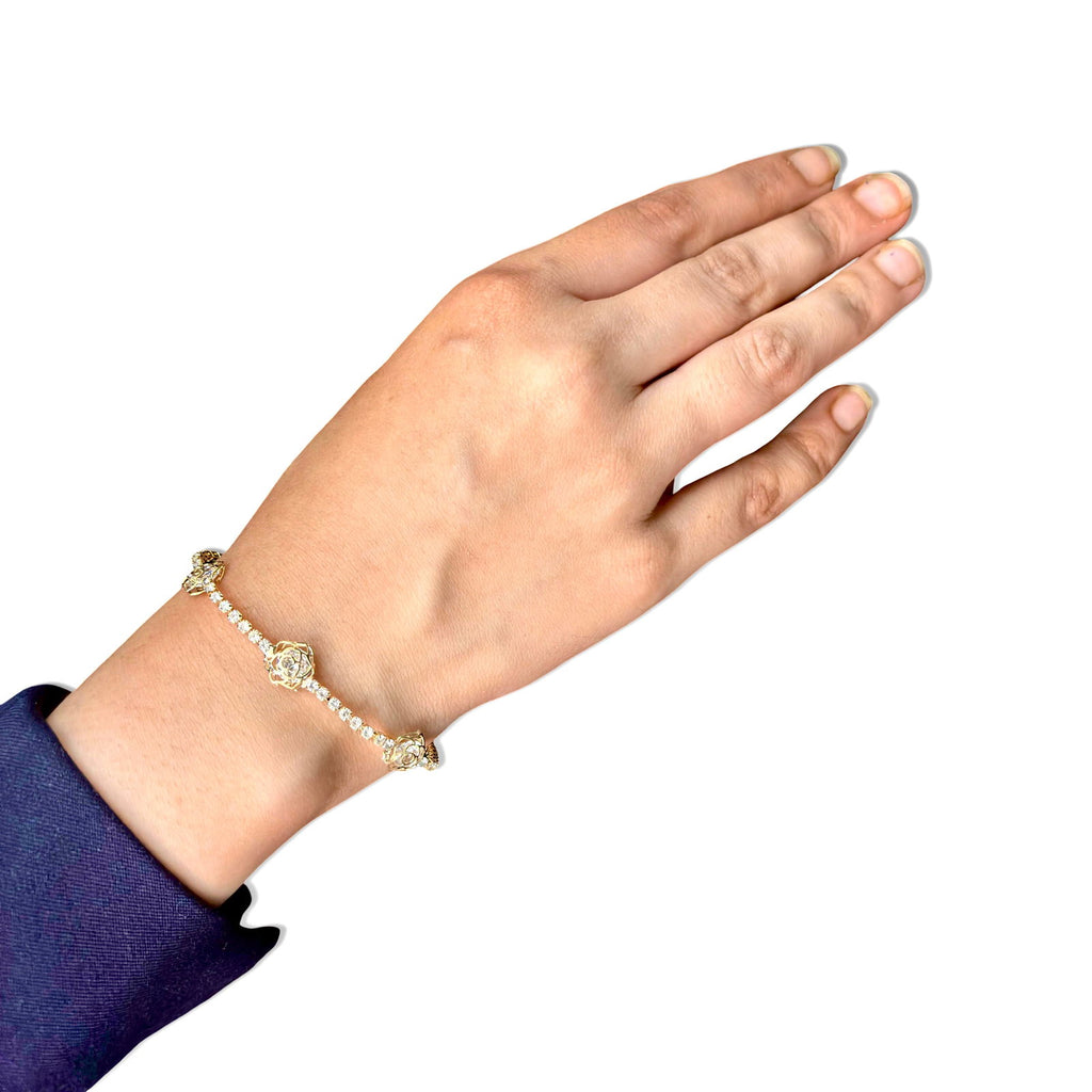 Model's hand on white background showcasing gold plated tennis bracelet - hypoallergenic tennis bracelet waterproof - cz tennis bracelet waterproof - budget tennis bracelet stainless steel - tennis bracelet everyday wear - tennis bracelet gift for her