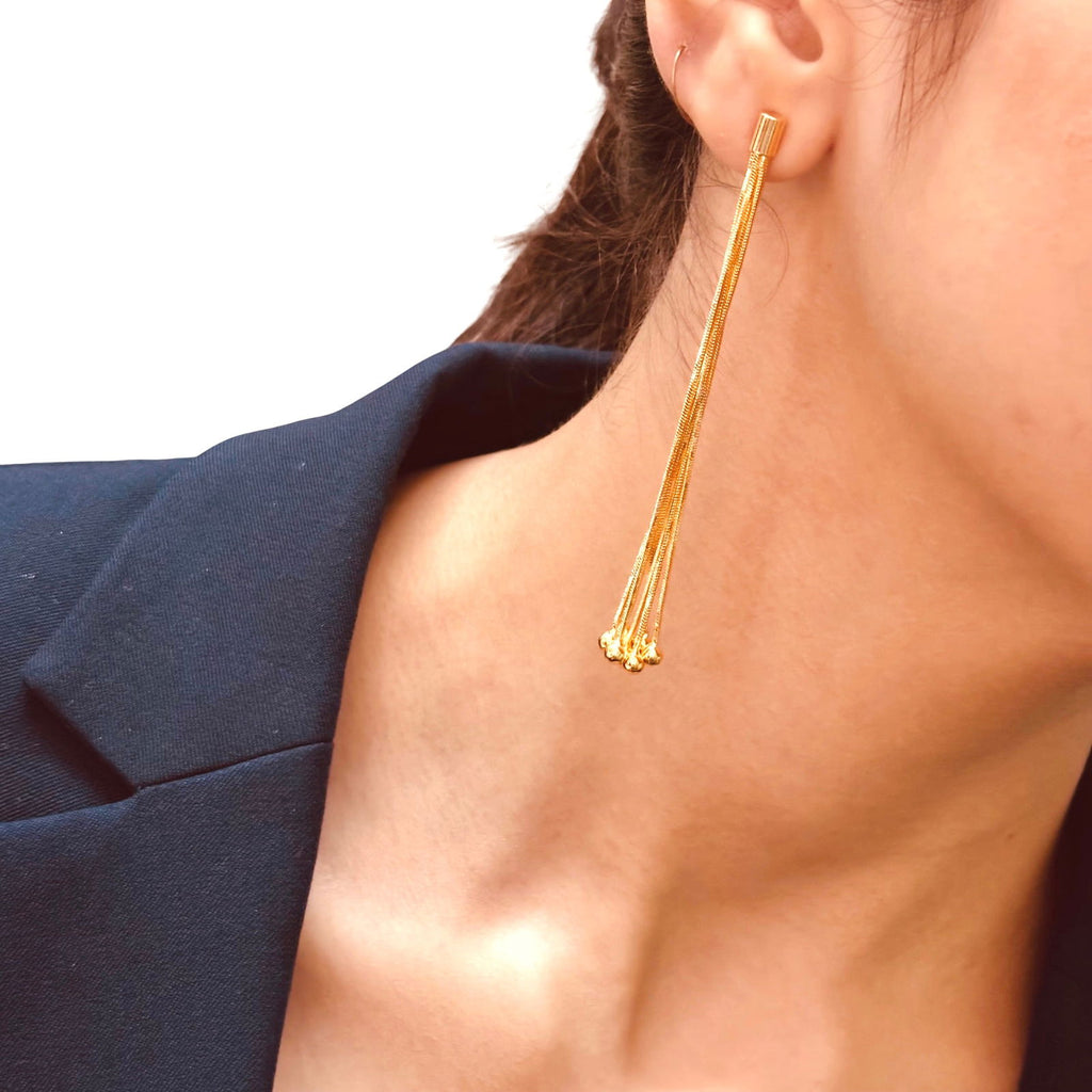 Model's close-up shot showing multi-chain tassel earrings layered chain design - Statement bold elegant gold plated earrings - hypoallergenic anti‑tarnish 18K gold plated party earrings - scratch‑resistant waterproof gold plated long earrings - Rakhi gifts for sister under 2000 - jewelry Raksha Bandhan gifts