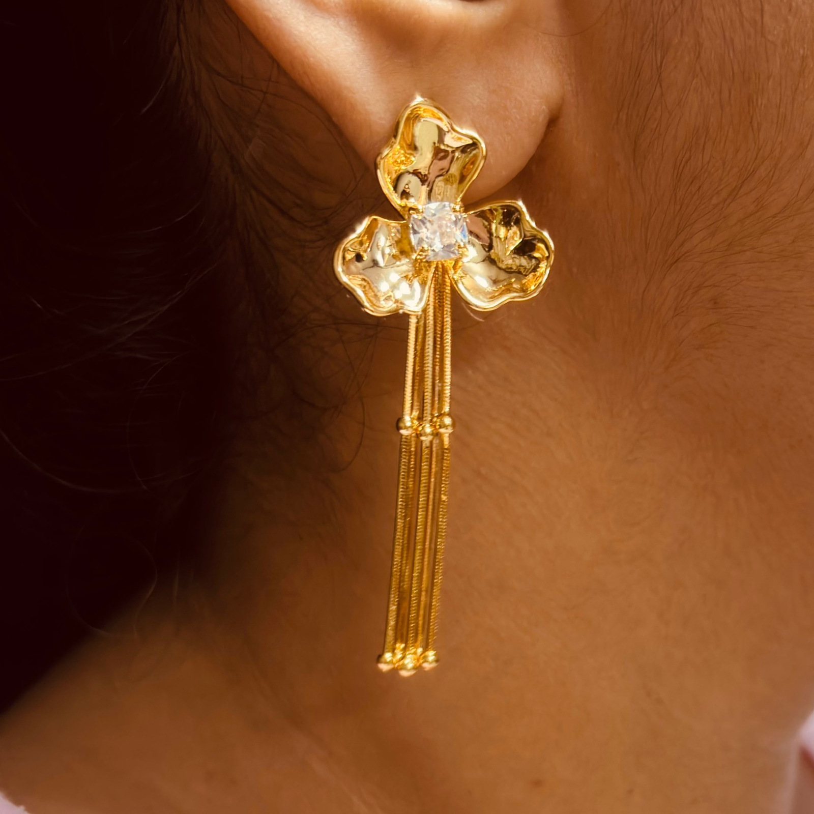 Model wearing delicate three petal flower earrings for casual elegance - party wear, elegant earring